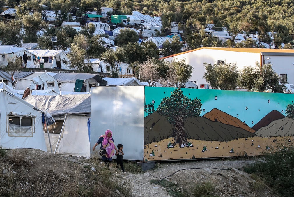 A part of Moria refugee camp on the Greek island of Lesbos. In the distance is the Turkish coastline. In October, the UN said 12,600 people were living in the camp, five times its capacity